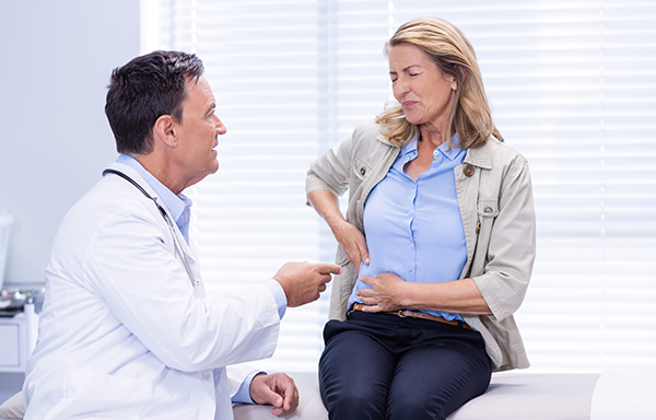 woman suffering from stomach pain seeking treatment with Gastroenterologist in Westchester County, NY